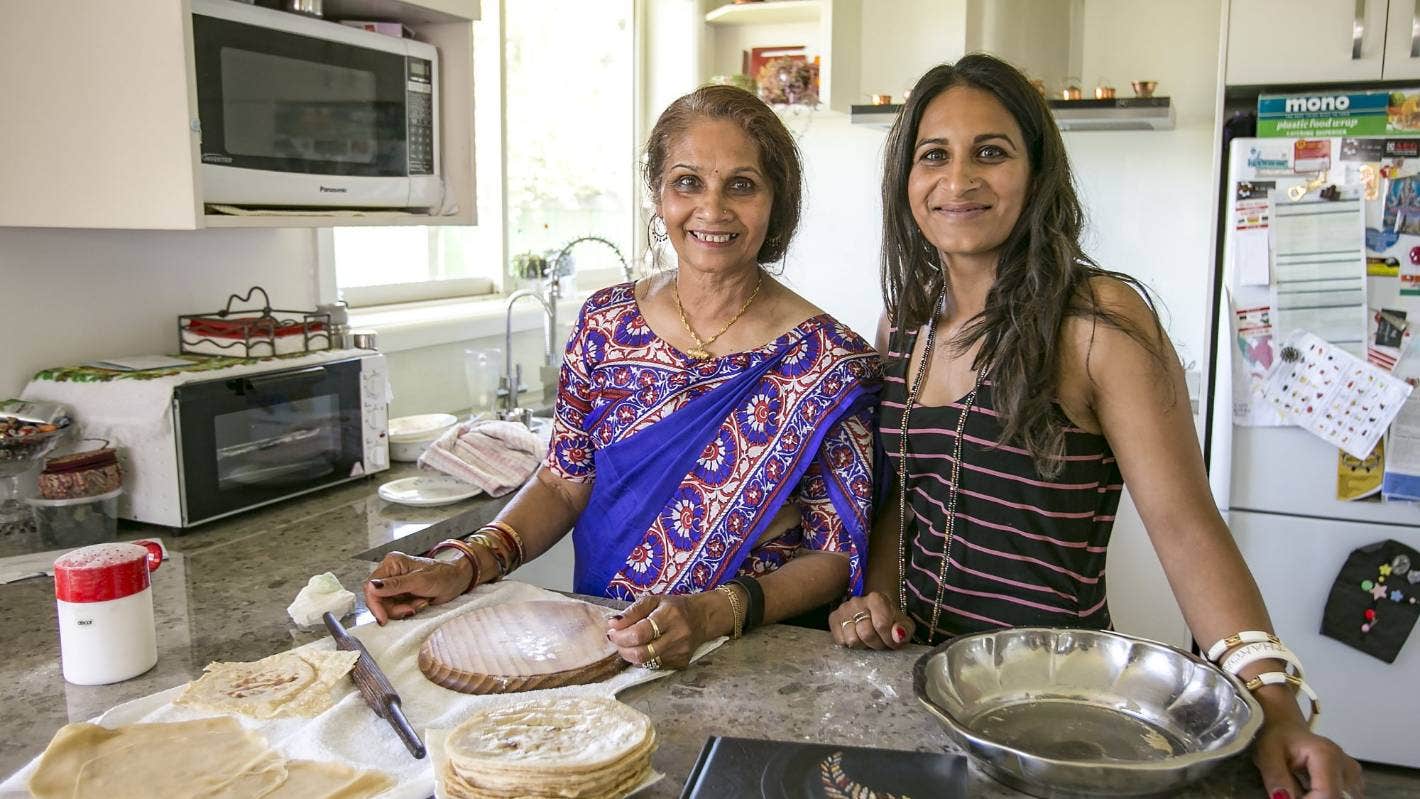 Jayshri Ganda and her Mother Laxmi Ganda in Laxmi's New Zealand kitchen with Rotli ingredients and tools