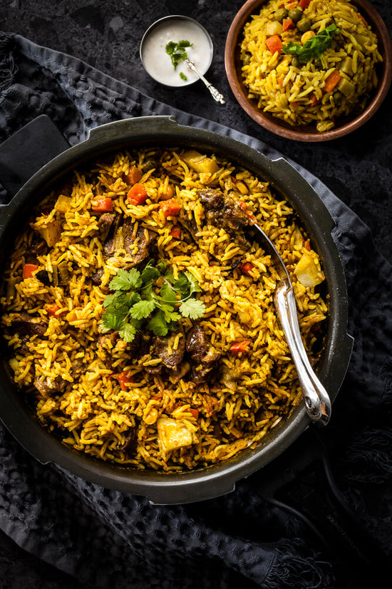 Lamb Biryani in pressure cooker with vegetables and yoghurt sauce