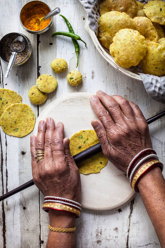Older lady hand rolling Masala Puri poori known as gujarati tikki puri