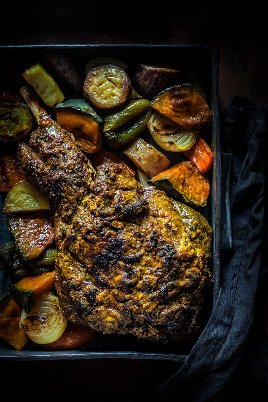 Masala Roast lamb filled of spices and roast vegetables in oven tray