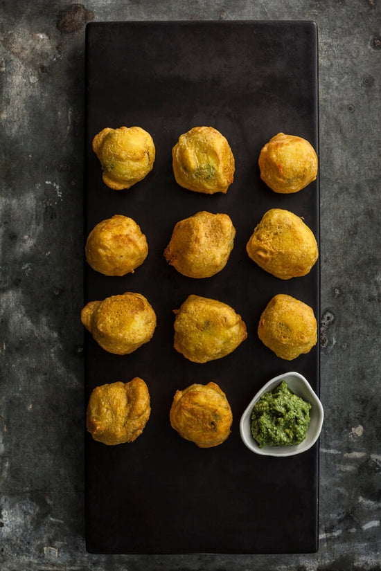 Bataka vada, Bateta Vada, spiced mashed potato balls, battered in channa besan flour mixture then deep fried
