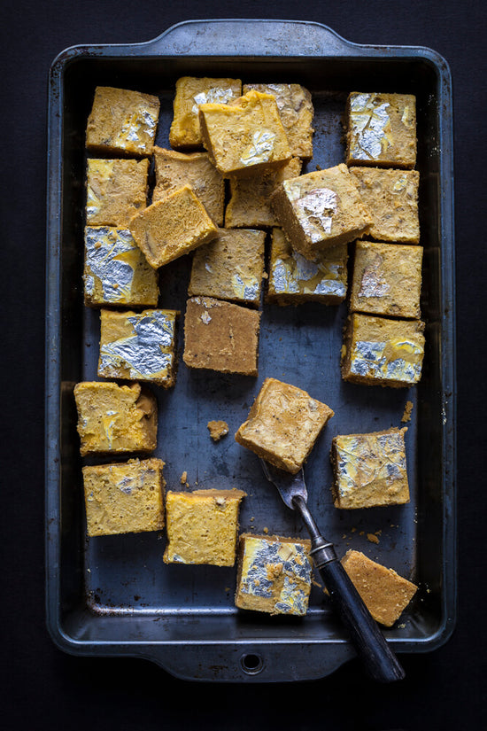 Gujarati Magaaj, chaaka, a lentil based slice in a tray with silver leaf