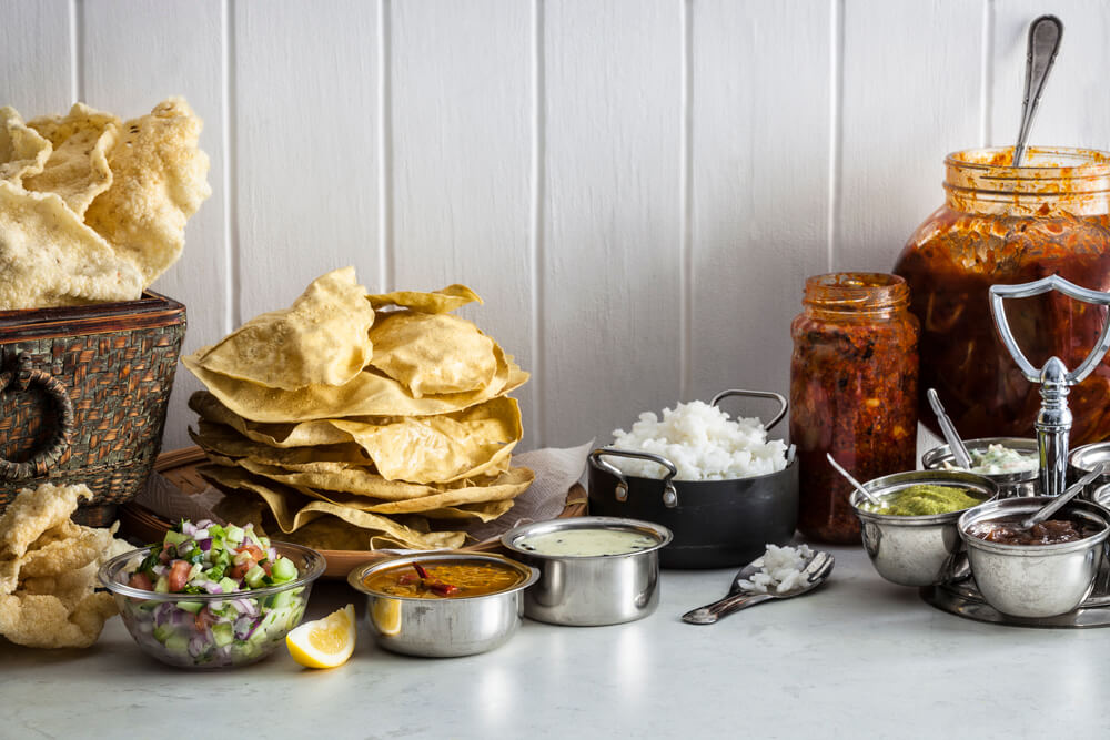 Papaddoms, kachumber, dahl, kadhi, artarnna, coriander chutney, lemon pickle, mango pickle, kechiya, rice