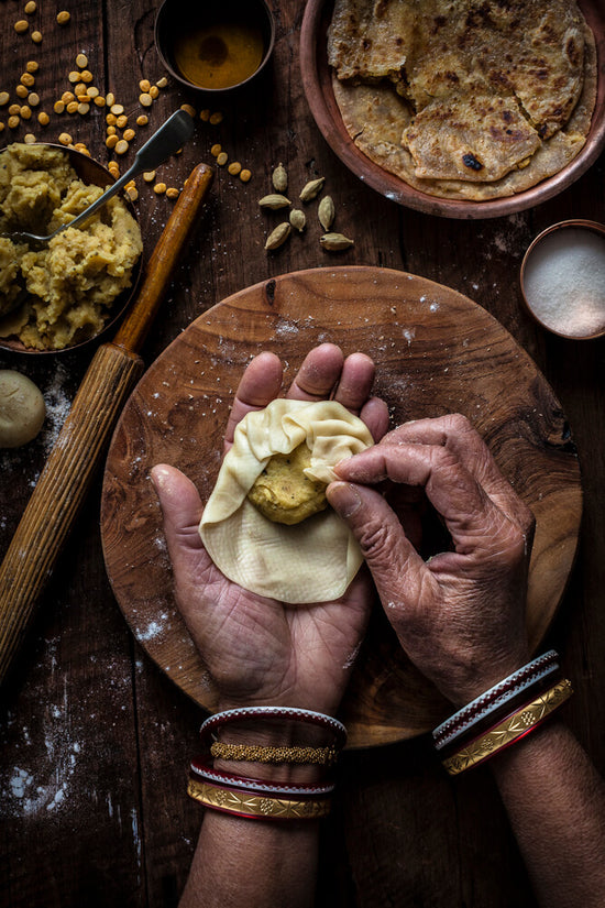 Indian hand folding Gahri Rotli, filling of spiced lentils. Pronounced garee rotli