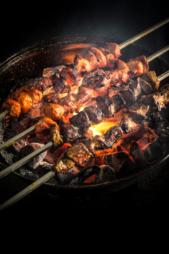 Masala Lamb and Chicken pieces on charcoal barbeque