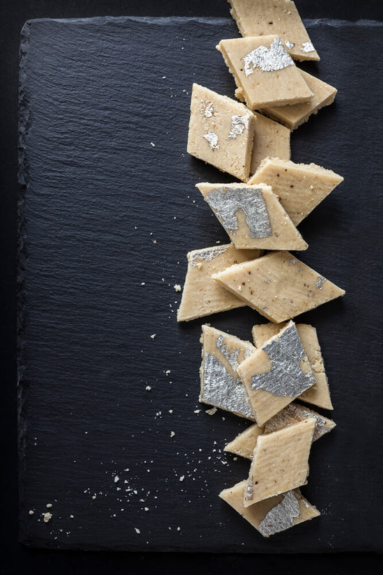 Kaju Katli, a Indian Cashew slice in diamonds shapes with silver leaf
