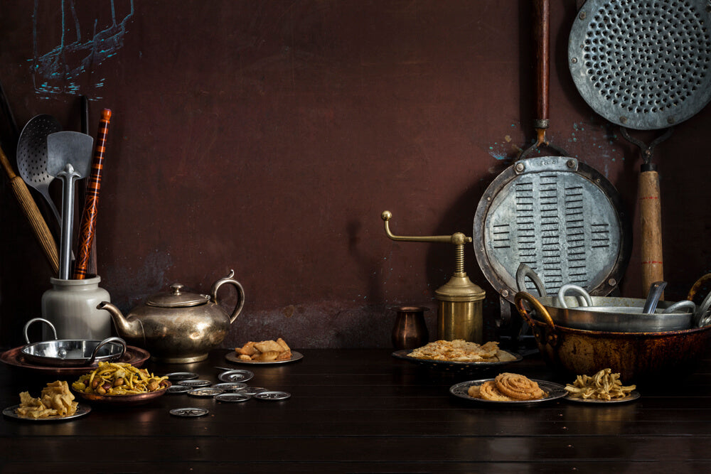 Gujarati Snacks, nasto, fafda, chakri, ganthiya, sev maker, fafda jarda, rolling pins, ganthiya jarda, bhuja mix, chevdo, teapot, sev maker cutters, on copper background