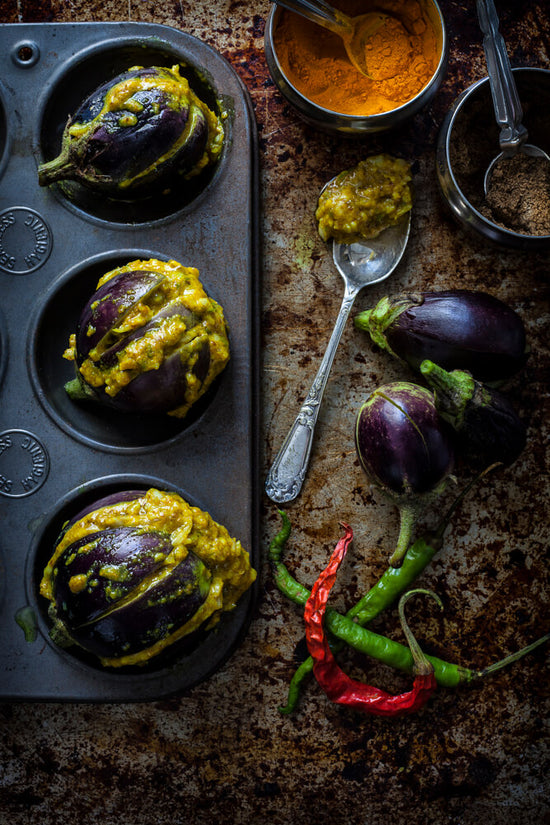 ringan na raveya, stuffed eggplants, turmeric, chillis, mixture on a spoon